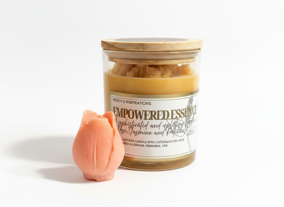 PMJ Candles Empowered Essence soy wax candle in a glass jar with a wooden lid and a peach-colored tulip wax melt.