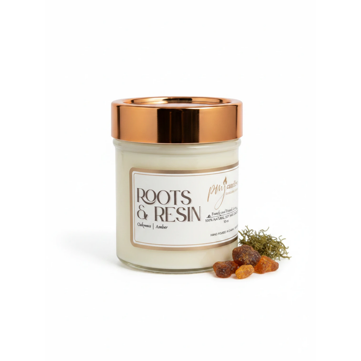 PMJ Candles Roots and Resin soy candle in a glass jar with a metallic copper lid, featuring amber and oakmoss accents.